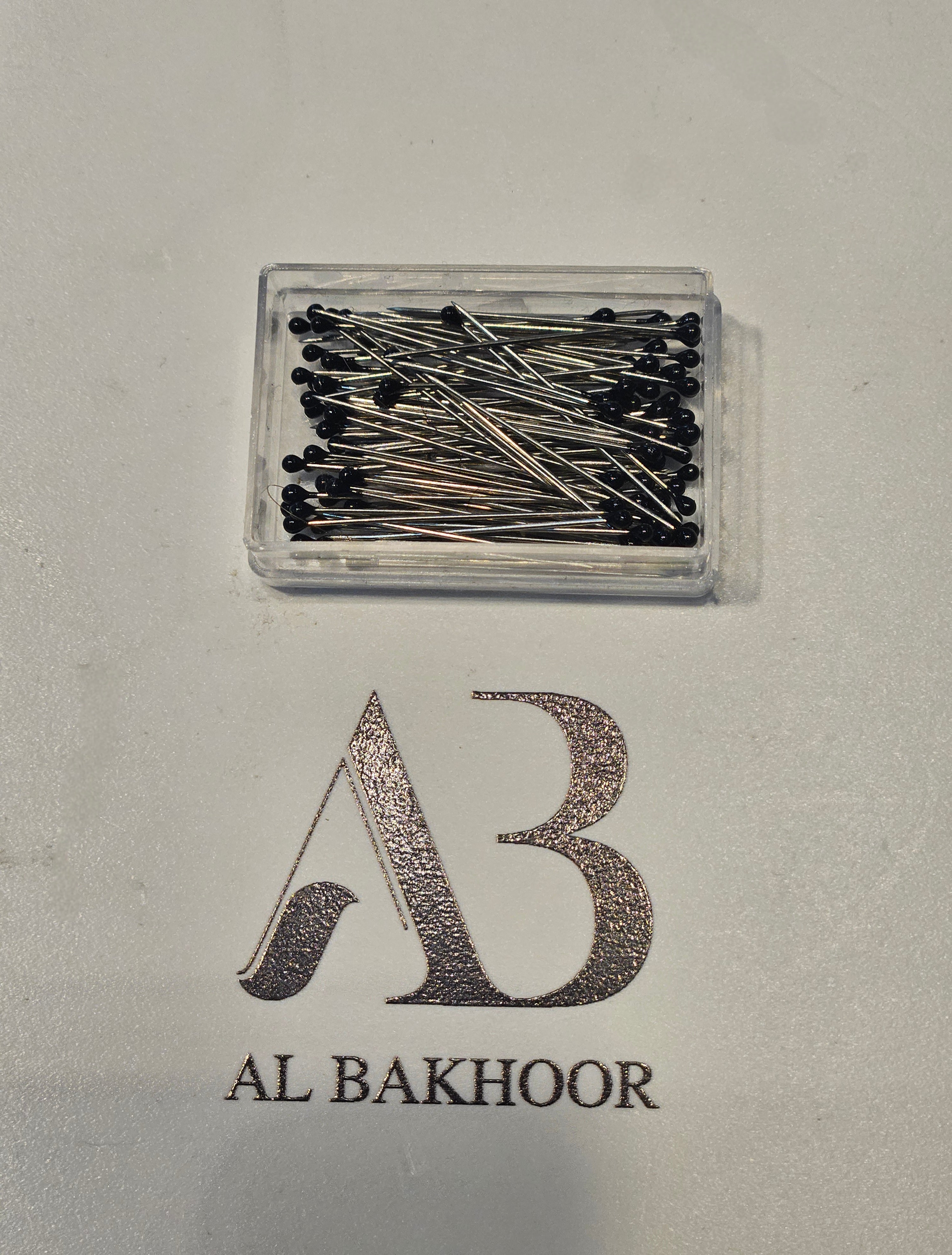 Box of black pins for hijab